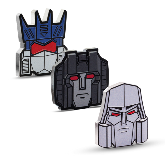 Three robot head-shaped pins with different color schemes on a white background